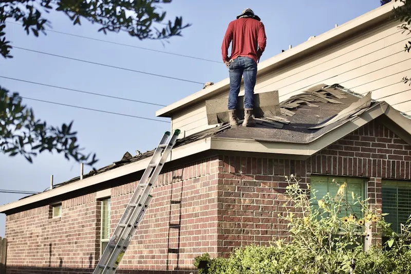 Professional roofer working on a residential roof in Maceys Corner